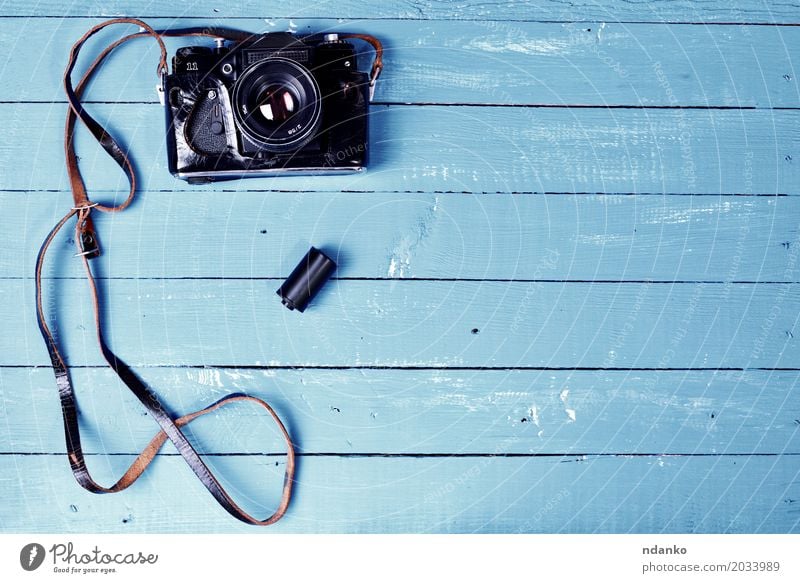 Vintage camera in a leather case on a blue wooden surface Camera Wood Old Retro Blue Brown Photography cover blank space device Top Shabby vintage board Lens