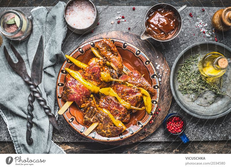 Spicy meat skewers with pepperoni on a rustic kitchen table Food Meat Herbs and spices Cooking oil Nutrition Dinner Picnic Organic produce Crockery Bowl Knives