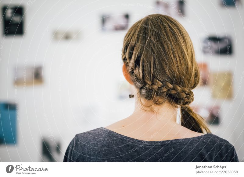 Back of a woman's head with braid In front of the picture wall with photos Hair and hairstyles Living room Human being Feminine girl Young woman