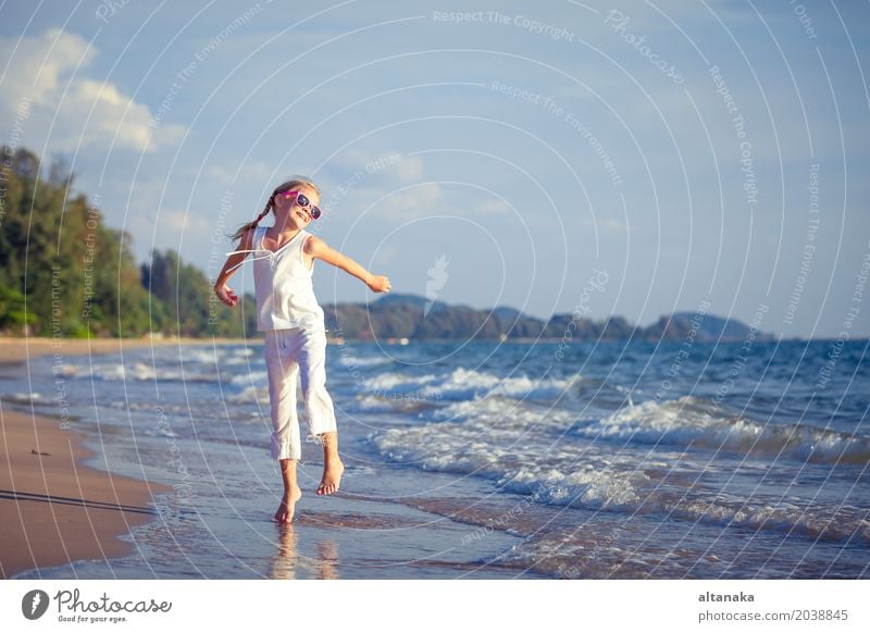 Little girl dancing on the beach at the day time Lifestyle Joy Happy Beautiful Relaxation Leisure and hobbies Playing Vacation & Travel Freedom Summer Sun Beach