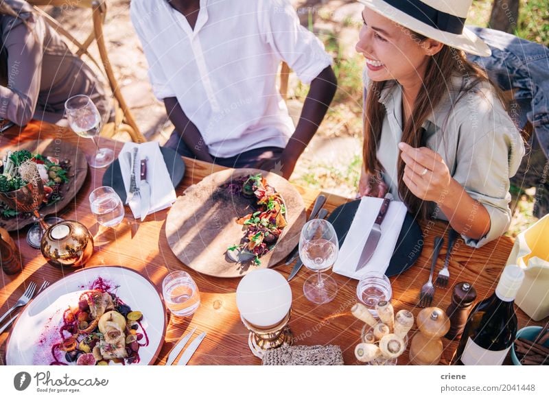 Group of young adult friends enjoying lunch together Eating Lunch Drinking Alcoholic drinks Plate Fork Lifestyle Summer Table Party Feminine Young woman