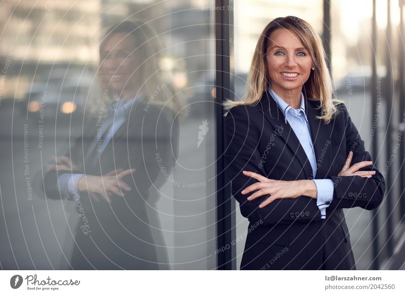 Single confident and attractive female businesswoman Happy Business Woman Adults 1 Human being 30 - 45 years Suit Blonde Smiling Stand Modern Blue