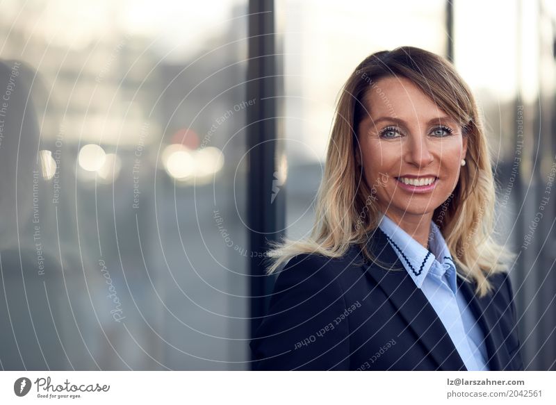 Confident female manager leaning on window Happy Face Business Woman Adults 1 Human being 30 - 45 years Suit Blonde Smiling Stand Modern Blue Self-confident ceo