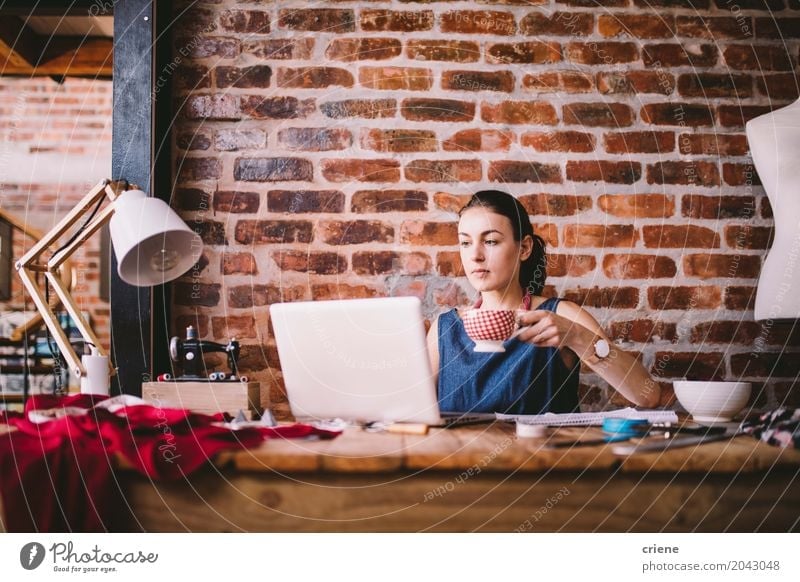Young businesswoman working on laptop and drinking coffee Drinking Coffee Lifestyle Leisure and hobbies Living or residing Desk Work and employment Office