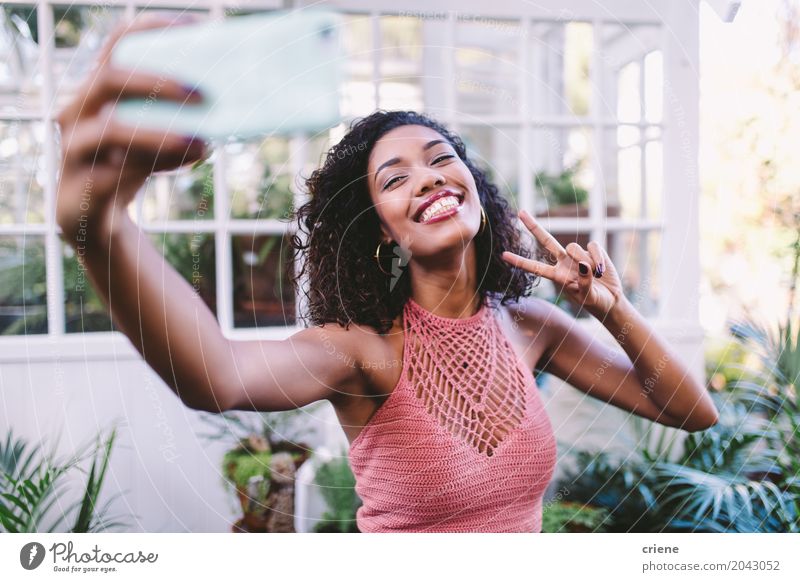 Happy African young woman taking selfie with phone Lifestyle Joy Summer Garden Telephone Cellphone PDA Camera Technology Entertainment electronics Internet