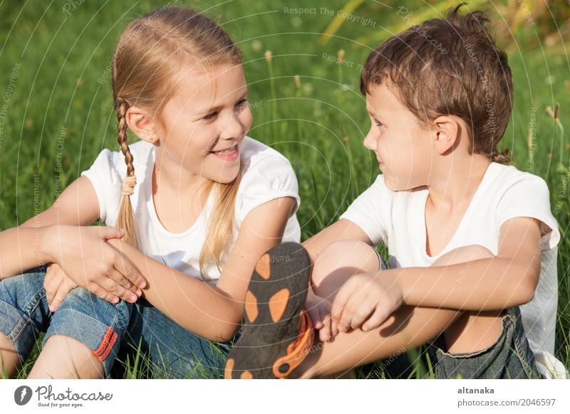 Two happy children playing near a tree on the grass Lifestyle Joy Happy Beautiful Face Leisure and hobbies Playing Vacation & Travel Freedom Summer Child