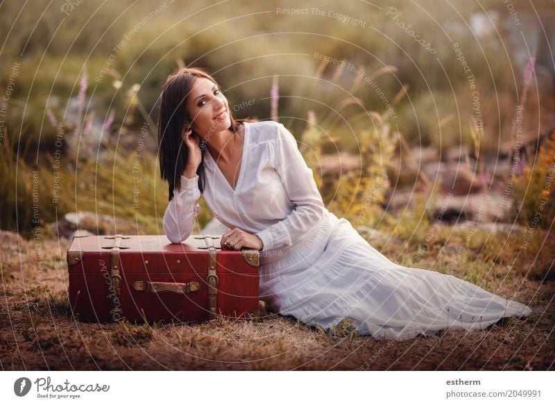 Woman sitting in the field with suitcase Lifestyle Elegant Style Beautiful Wellness Vacation & Travel Trip Adventure Freedom Human being Feminine Young woman