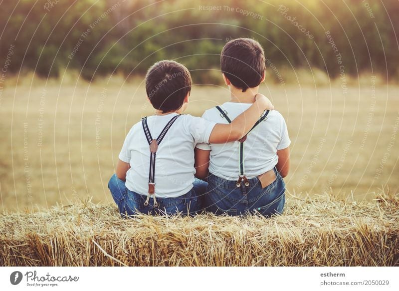 Brothers embraced sitting in the field Lifestyle Children's game Human being Toddler Boy (child) Brothers and sisters Family & Relations Friendship Infancy 2