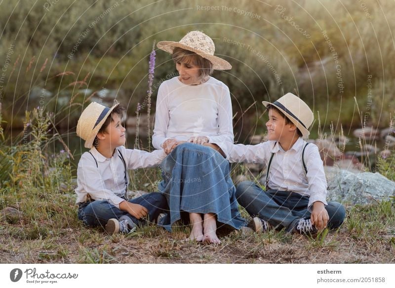 Grandmother with her grandchildren sitting in the field Lifestyle Joy Garden Human being Masculine Feminine Child Toddler Boy (child) Brothers and sisters