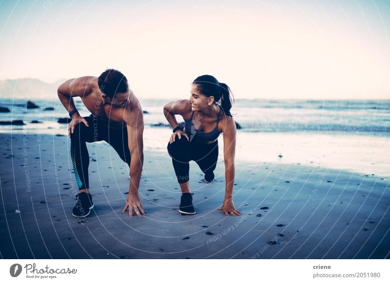 Adult fitness couple doing exercise together on beach Lifestyle Joy Body Beach Ocean Sports Young woman Youth (Young adults) Young man Couple 2 Human being