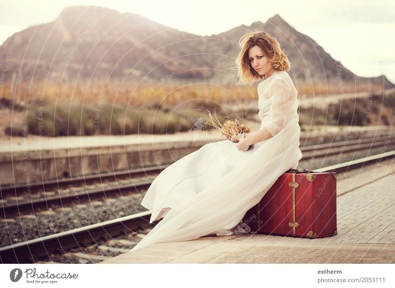 Pensive bride with a red suitcase on the train tracks Lifestyle Elegant Style Design Beautiful Vacation & Travel Tourism Trip Adventure Freedom Wedding