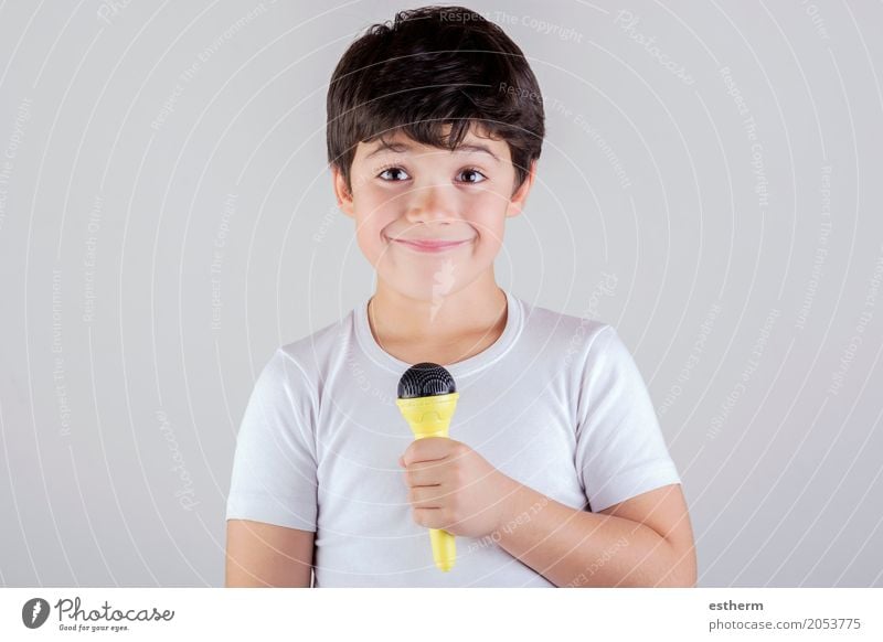 Boy singing to microphone Lifestyle Joy Leisure and hobbies Human being Child Toddler Boy (child) Infancy 1 3 - 8 years Stage play Music Singer Smiling Laughter