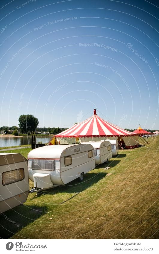 Wandering circus traffic jam Entertainment Event Music festival Feasts & Celebrations Fairs & Carnivals Sky Summer Beautiful weather Grass Coast River bank