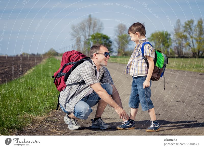 Father and son walking on the road at the day time. Lifestyle Joy Happy Leisure and hobbies Vacation & Travel Tourism Trip Adventure Freedom Camping Summer