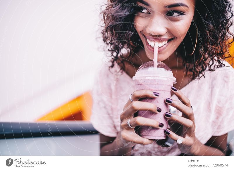Happy Woman drinking a fresh strawberry smoothie Fruit Beverage Drinking Lifestyle Beautiful Summer Feminine Young woman Youth (Young adults) 1 Human being Afro