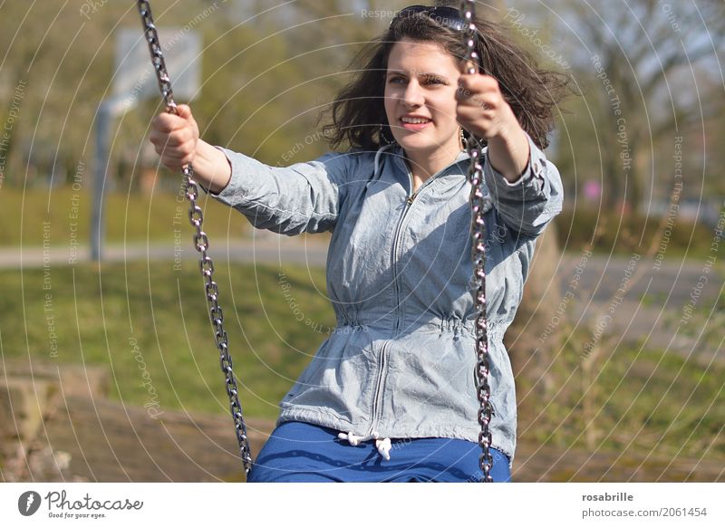 Having fun in life - young woman sitting on a swing in a park Human being Feminine Young woman Youth (Young adults) Woman Adults 1 18 - 30 years Jacket
