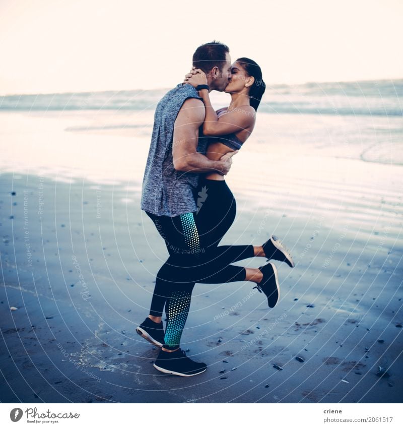 Fitness couple kissing on the beach Lifestyle Joy Happy Leisure and hobbies Beach Ocean Sports Sports Training Human being Young woman Youth (Young adults)
