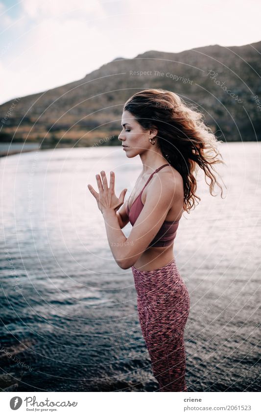 Beautiful woman practicing yoga by a lake Life Relaxation Meditation Yoga Teacher Human being Feminine Young woman Youth (Young adults) Woman Adults Body 1