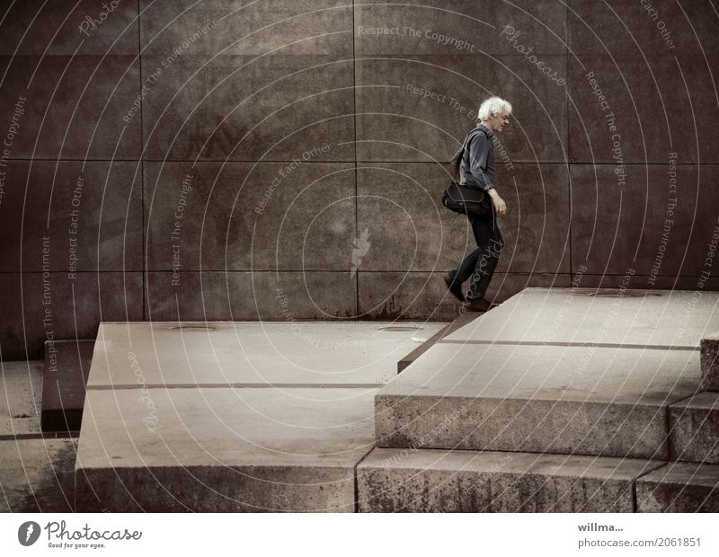 Not so steep anymore, but a climb is still possible even for older people. White haired attractive man climbing a flat staircase Man on one's own White-haired
