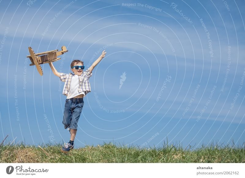 Little boy playing with cardboard toy airplane Lifestyle Joy Happy Playing Vacation & Travel Adventure Freedom Summer Sun Sports Success Child Pilot Human being