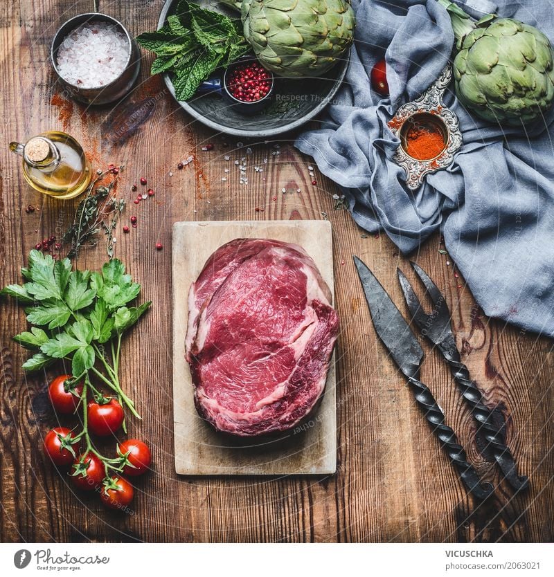 raw meat steaks with ingredients for grilling or cooking Food Meat Vegetable Herbs and spices Cooking oil Nutrition Organic produce Crockery Knives Fork Style