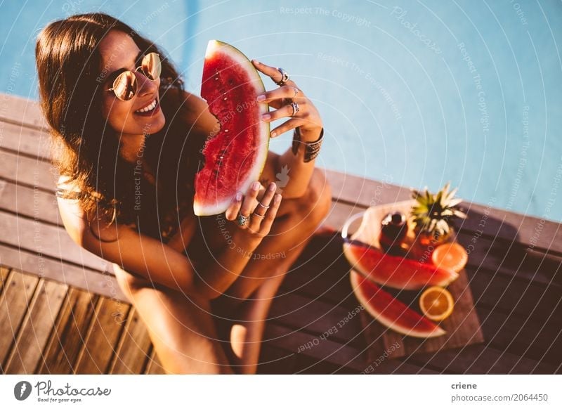 Young smiling female in swimsuit holding slice of watermelon Fruit Nutrition Eating Diet Lifestyle Healthy Eating Swimming pool Vacation & Travel Summer