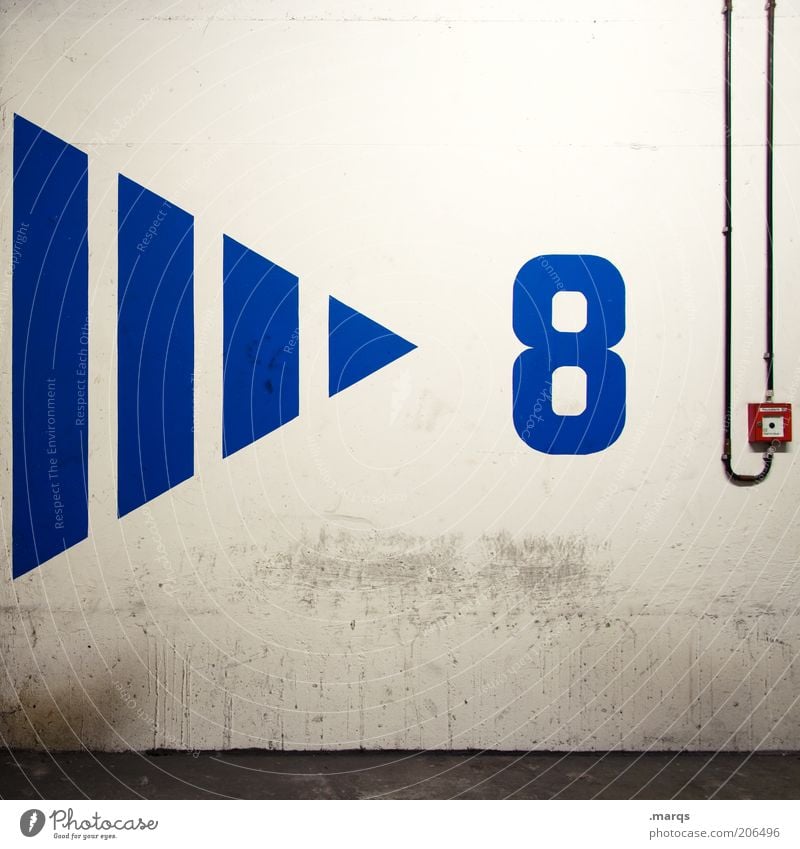 > 8 Wall (barrier) Wall (building) Concrete Digits and numbers Arrow Blue Fire alarm Colour photo Interior shot Artificial light Deserted Cable Switch Triangle