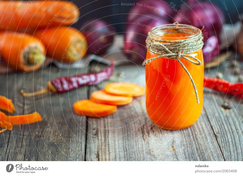 fresh carrot juice in a glass jar Vegetable Herbs and spices Vegetarian diet Diet Beverage Juice Glass Table Nature Autumn Wood Old Fresh Natural Juicy Gray