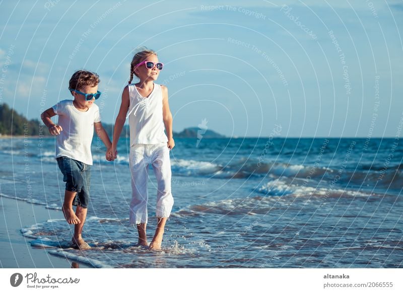 Happy children playing on the beach Lifestyle Joy Relaxation Leisure and hobbies Playing Vacation & Travel Adventure Freedom Summer Sun Beach Ocean Sports Child
