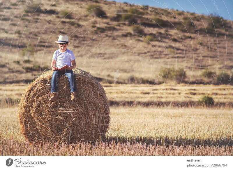 boy reading a book Lifestyle Joy Leisure and hobbies Playing Education Study Human being Masculine Child Toddler Boy (child) Infancy 1 3 - 8 years Hat Paper