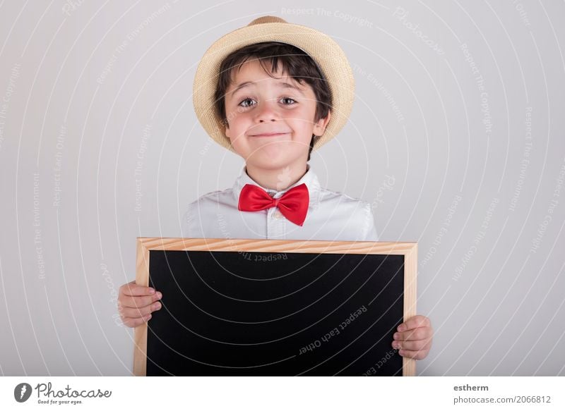 smiling child holding a blackboard Lifestyle Joy Child Blackboard Schoolchild Human being Masculine Toddler Boy (child) 1 3 - 8 years Infancy Tie Hat To hold on