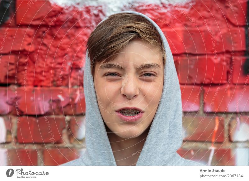 teenager with braces and hoodie Lifestyle Style Design Human being Masculine Young man Youth (Young adults) Face Teeth 1 13 - 18 years Wall (barrier)
