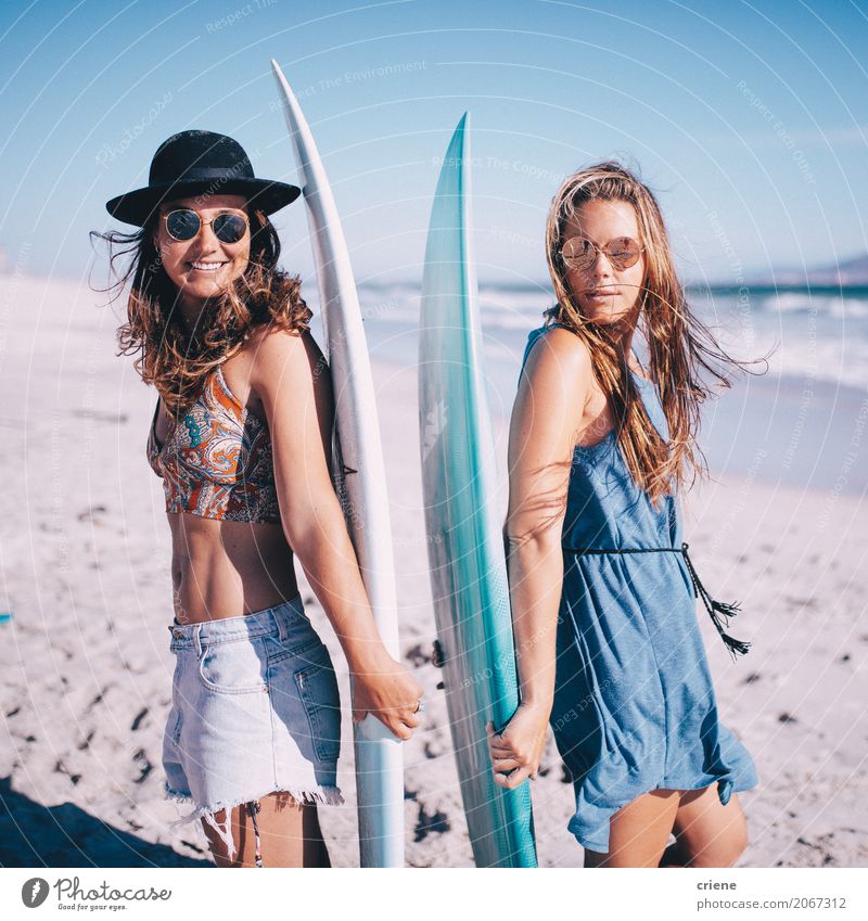 Portrait of two young woman with surfboards on beach Lifestyle Joy Leisure and hobbies Vacation & Travel Summer Sunbathing Beach Ocean Sports Human being