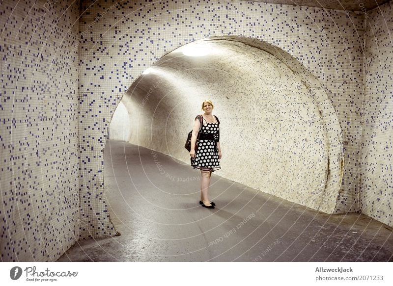 Woman with dress in front of an illuminated underpass Night Evening Dark Lighting Artificial light Young woman 1 Person Dress Tunnel Underpass Passage Pipe