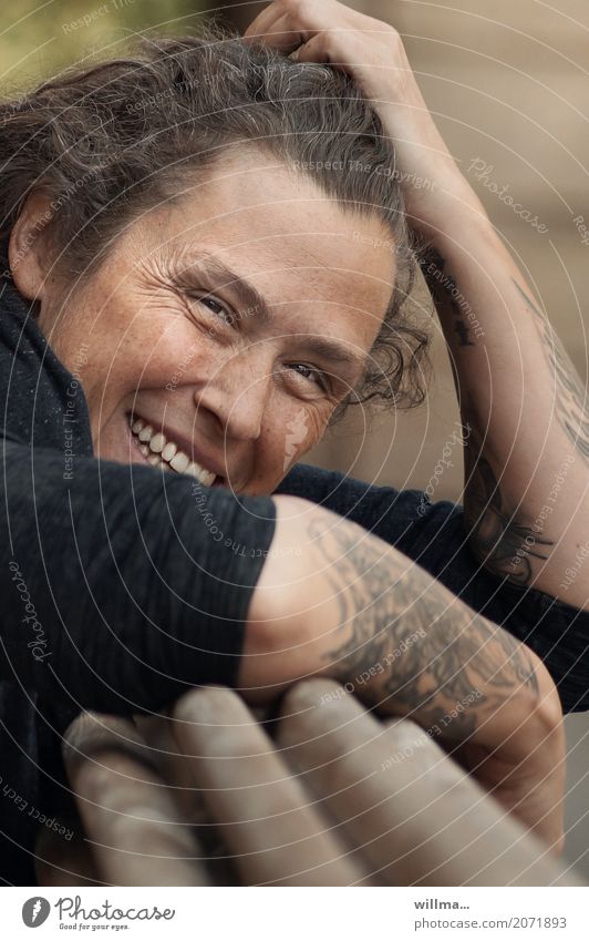 Smile lines, freckles and tattoos portrait Laugh lines Laughter lines Tattooed Young woman Face Arm Smiling Cool (slang) Easygoing Friendliness Curly