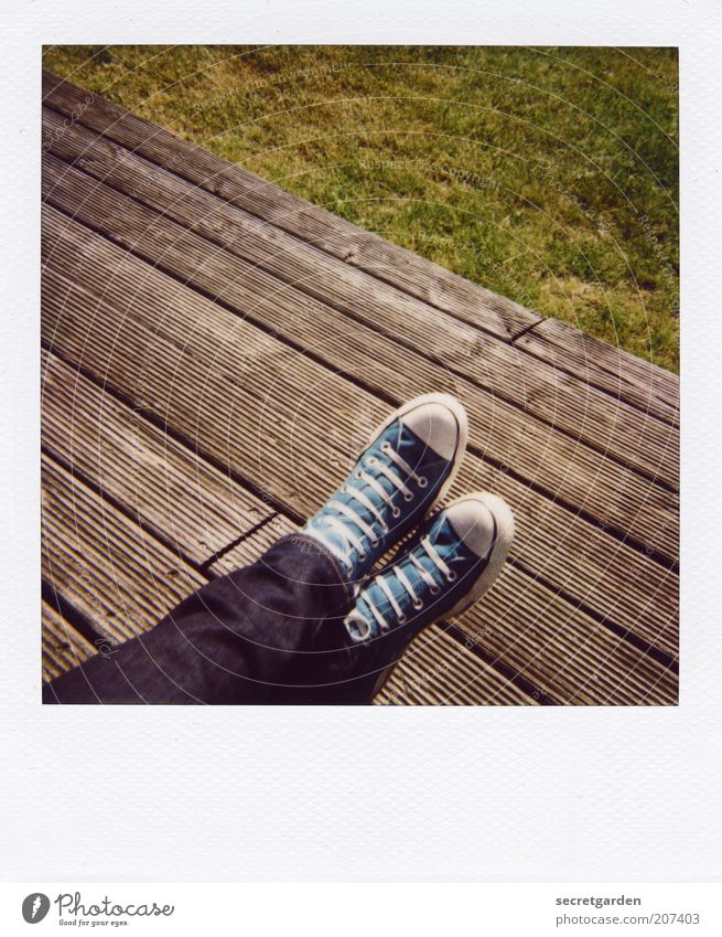 [H 10.1] Count's feet. Well-being Contentment Relaxation Calm Summer Human being Legs Feet Beautiful weather Grass Terrace Jeans Footwear Sneakers Chucks Wood