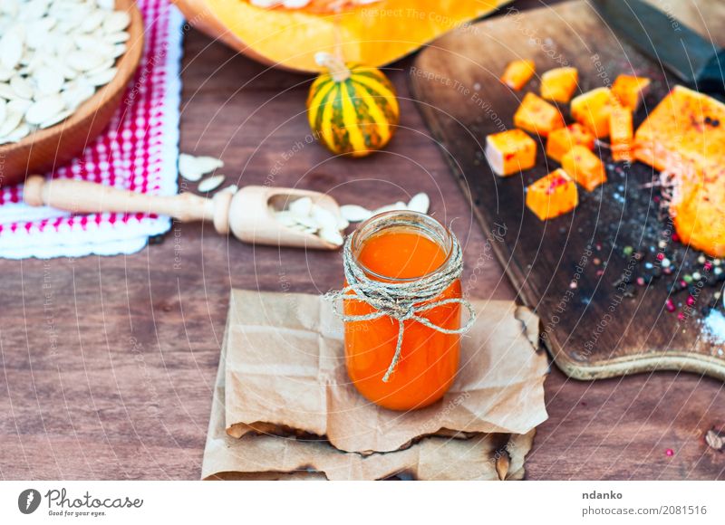 Pumpkin juice with spices Herbs and spices Juice Spoon Paper Wood Fresh Natural Above Brown White glass Useful pepper paprika orange knife cook seasoning