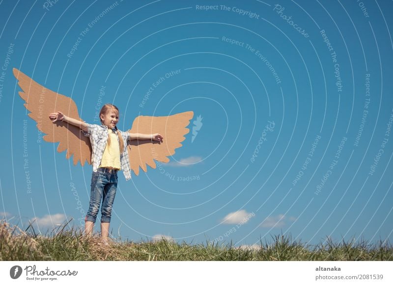 Little girl playing with cardboard toy wings in the park Lifestyle Joy Happy Playing Vacation & Travel Adventure Freedom Summer Sun Sports Success Child Pilot