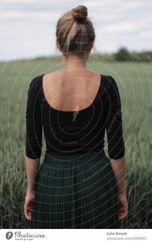 Beautiful woman with bun in green pleated skirt in front of rye field Feminine Young woman Youth (Young adults) Woman Adults Back 1 Human being 18 - 30 years