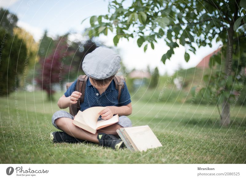 enrolment Child Boy (child) Infancy 1 Human being 3 - 8 years Discover Study Reading Sit First day at school Cap Satchel Book Garden Exterior shot School