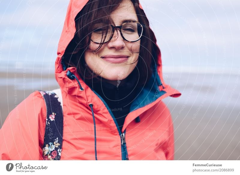 Young woman with glasses and red rain jacket at the sea Feminine Youth (Young adults) Woman Adults 1 Human being 18 - 30 years 30 - 45 years Nature Rain jacket