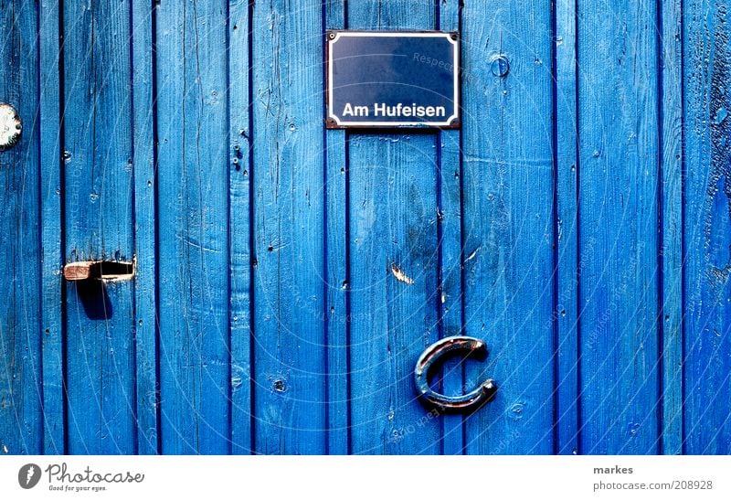 @home Door Blue Happy Colour Surrealism Horseshoe Name plate Bright light Colour photo Exterior shot Deserted Day Sunlight Deep depth of field