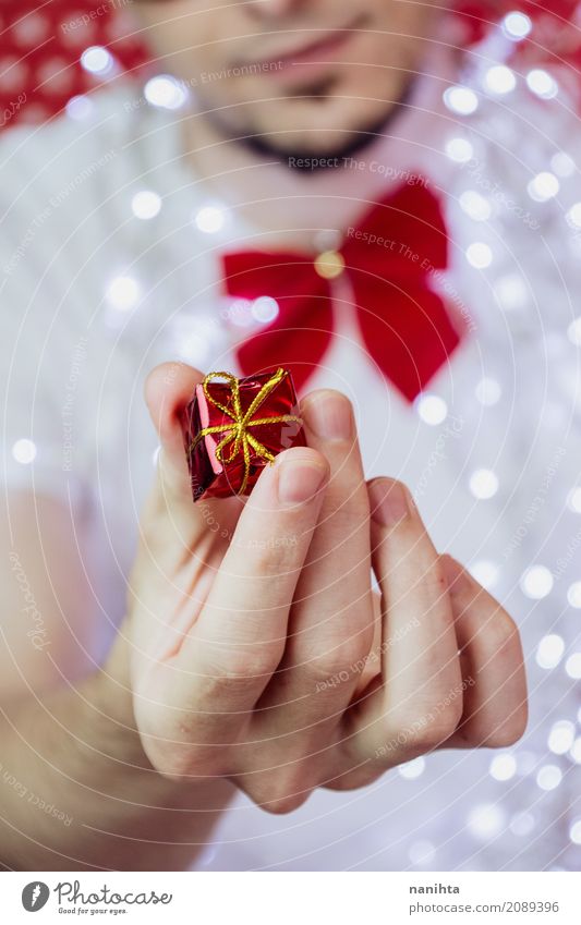 Young man sharing a christmas gift Lifestyle Elegant Style Wellness Feasts & Celebrations Christmas & Advent New Year's Eve Human being Masculine