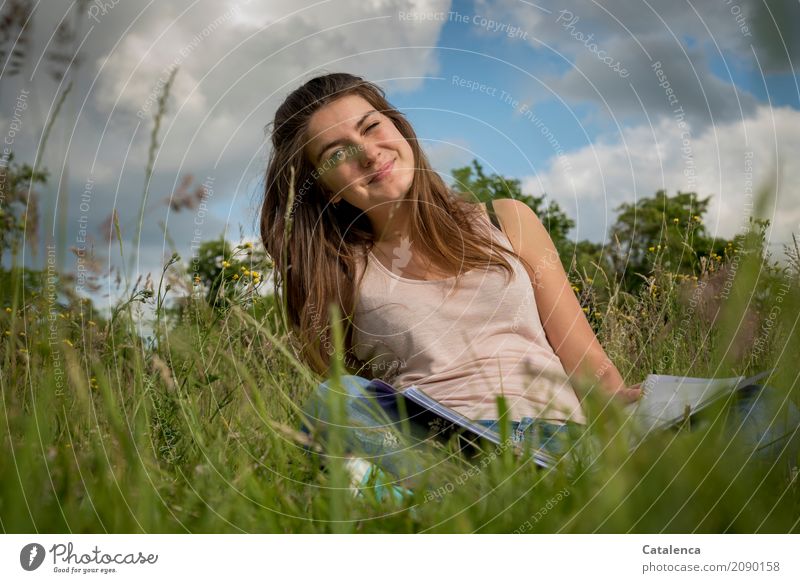 Young woman on meadow smiles and squints one eye Education Study Feminine Youth (Young adults) 1 Human being 18 - 30 years Adults Nature Sky Clouds Summer