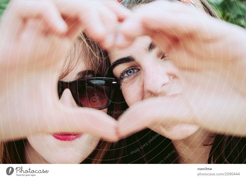 Two young women making a heart with their hands Lifestyle Joy Face Wellness Well-being Human being Feminine Young woman Youth (Young adults) Family & Relations