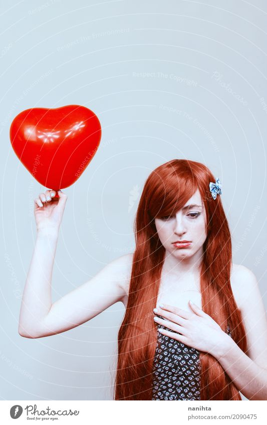Young sad woman holding a heart shaped balloon Valentine's Day Human being Feminine Young woman Youth (Young adults) 1 18 - 30 years Adults Red-haired