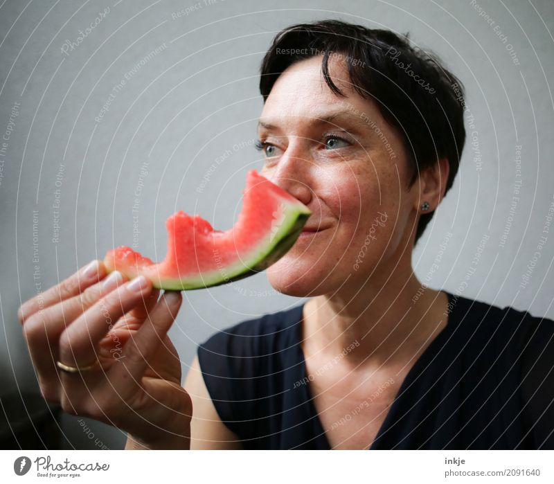 Amused happy smiling caucasian woman still chewing watermelon Fruit Water melon Melon Nutrition Eating Organic produce Vegetarian diet Slow food Finger food