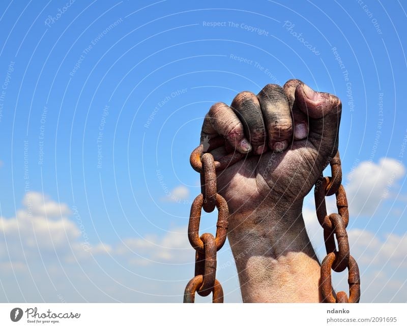 Rusty iron chain in human male right hand Skin Freedom Masculine Hand Fingers Sky Metal Steel Old Dirty Strong Blue Brown Black Power Might Protection