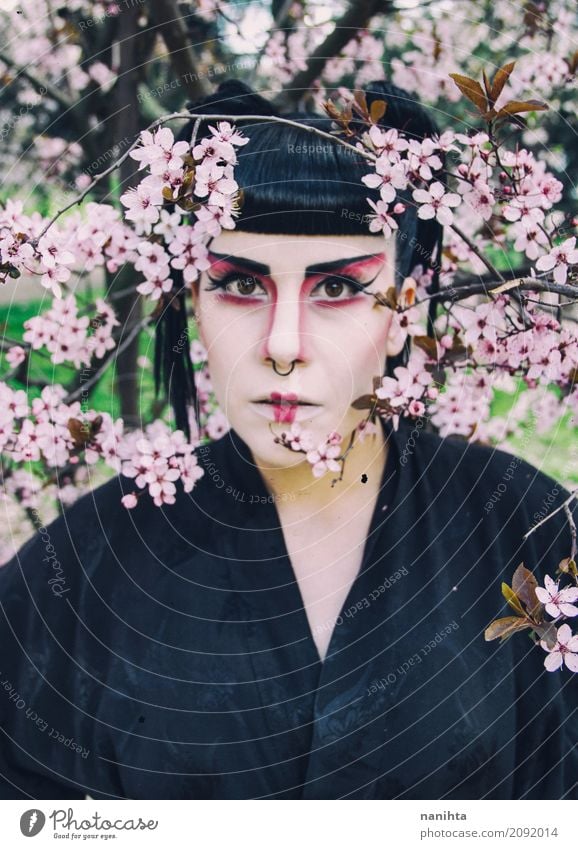 Young woman with geisha makeup posing with flowers Style Design Exotic Beautiful Hair and hairstyles Face Make-up Lipstick Feasts & Celebrations Carnival
