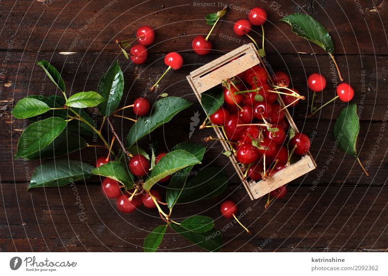 Fresh sour cherries in a box on a wooden table Fruit Vegetarian diet Diet Bowl Summer Table Leaf Dark Delicious Juicy Sour Wild Brown Green Red Berries Cherry